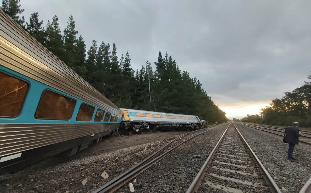 CRASH SCENE: The engine and the first carriage off the XPT train tipped onto their sides while others were leaning off the wrecked tracks in February. Investigations into the derailment continue. Picture: SCOTT RICKARD