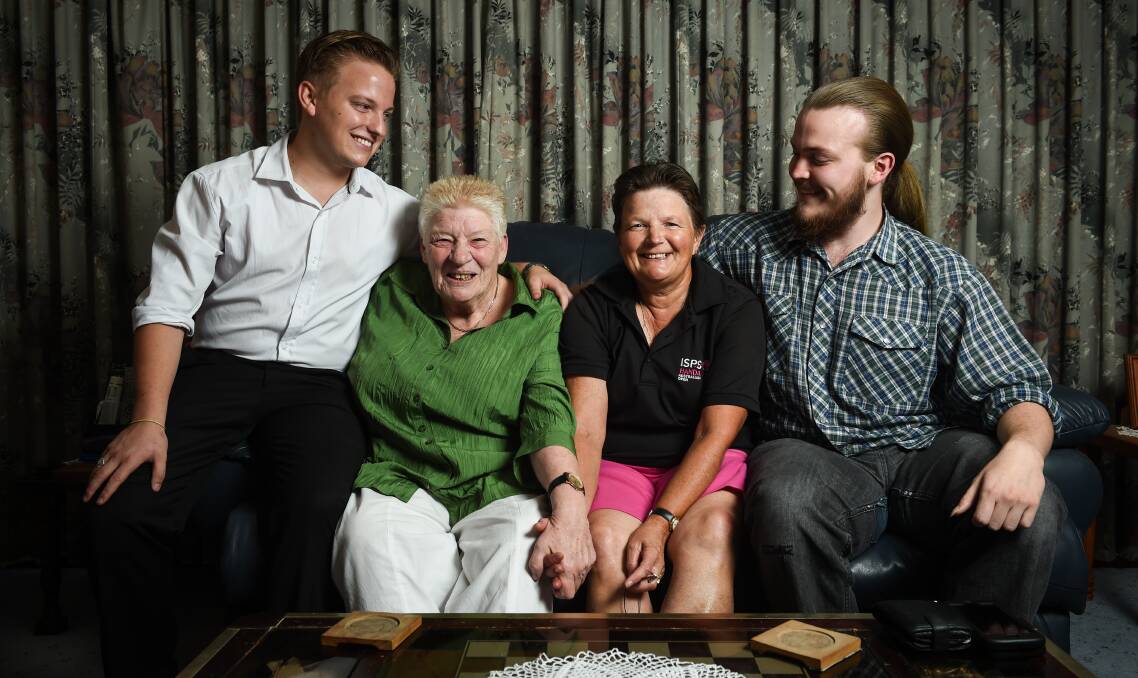 HAPPY FAMILY: Eric Kerr, mums Debra Brindley and Roslyn Kerr, and twin brother Jeremy Kerr have spent the past 22 years of the boys' lives growing up like any another Wodonga family. Picture: MARK JESSER