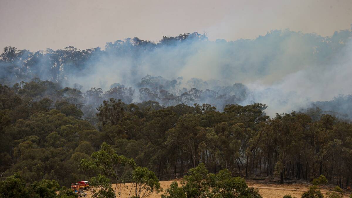 SMOKY SKIES: The bushfire continued to burn in Carboor late last week. Picture: JAMES WILTSHIRE