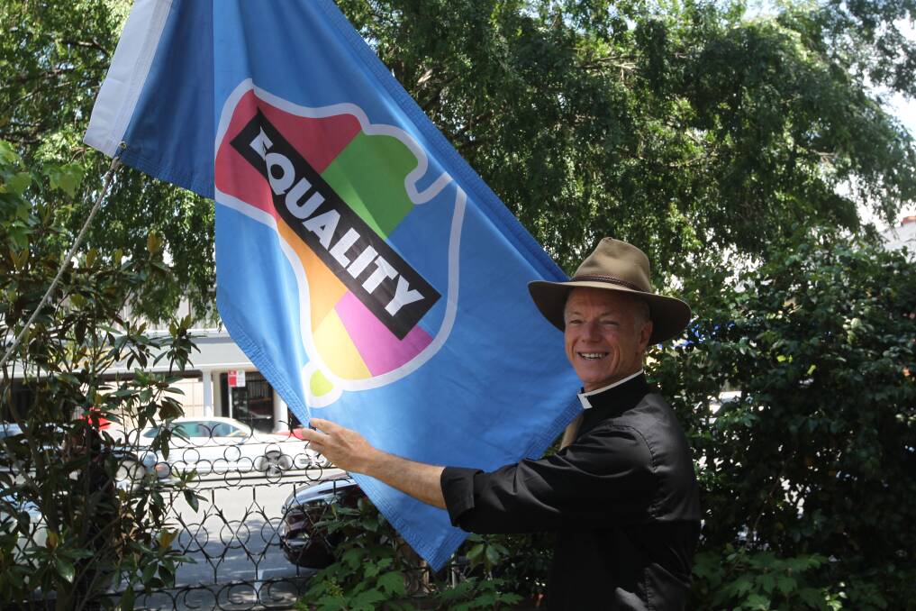 SUPPORTER: Albury's St Matthew's Anglican church Father Peter MacLeod-Miller raised an equality flag outside the church on Wednesday. Picture: SHANA MORGAN