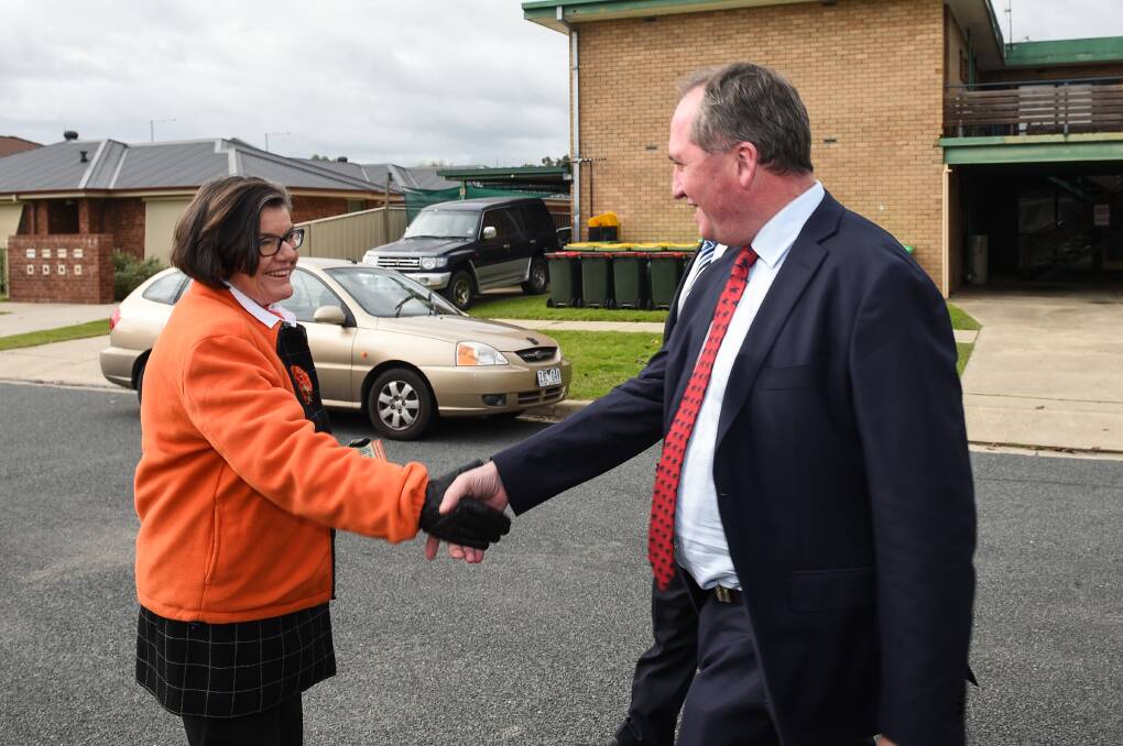 WARM MEETING: Cathy McGowan and Barnaby Joyce shake hands during a visit to Wodonga in 2016.
