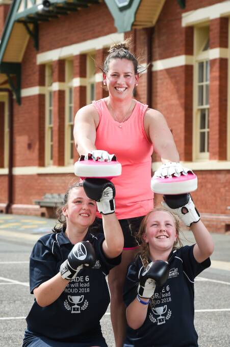 FUN EXERCISE: Rutherglen Primary School teacher Emily Harris has been promoting healthy eating and exercise to pupils including Jaida Maggs and Nikita Larson. Picture: MARK JESSER