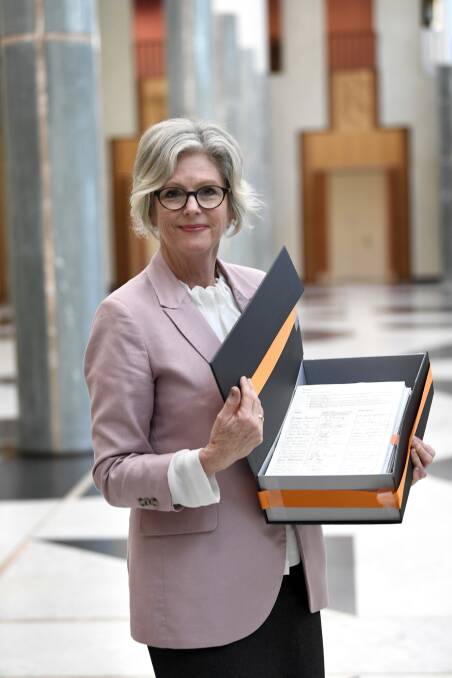 THE PEOPLE HAVE SPOKEN: Indi MP Helen Haines in Parliament House yesterday with the box of 1800 petitions presented to the government. Picture: DAVID FOOTE, APH
