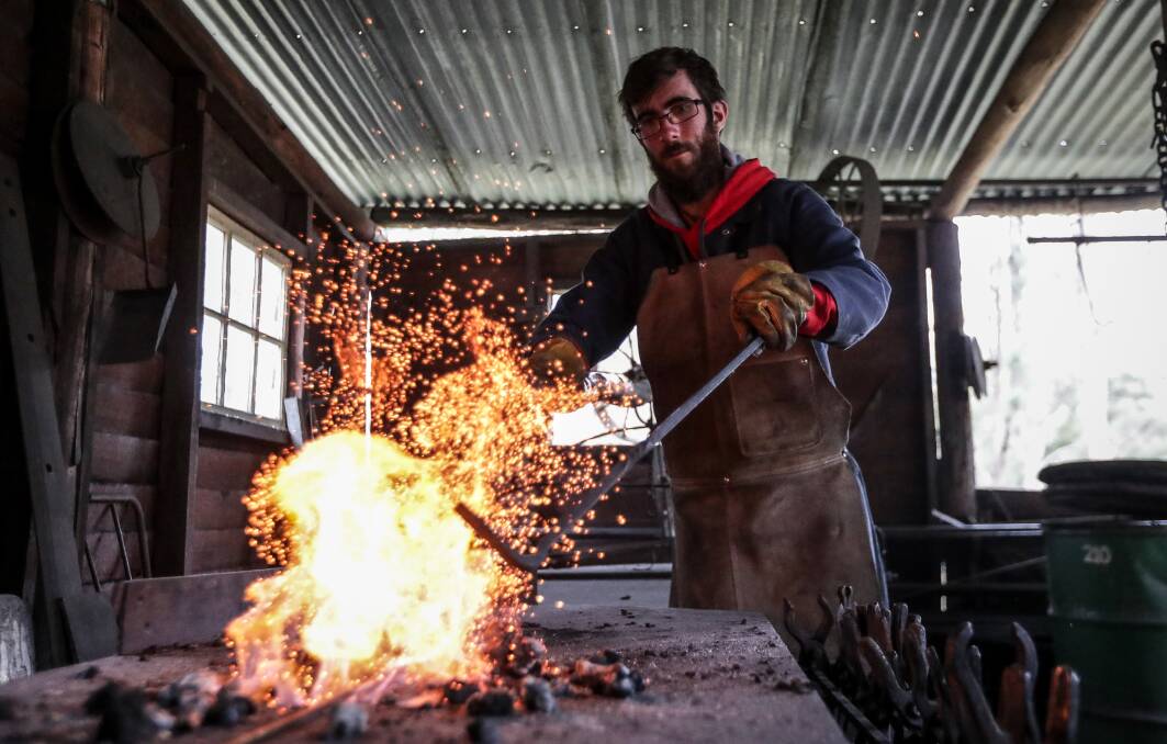 PIONEER SKILLS: Mittagundi worker Dáire Kelly shows students blacksmith skills on the farm.