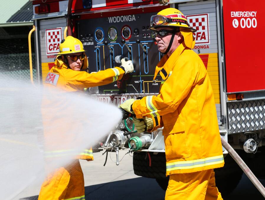 READY FOR ACTION: Wodonga Fire Brigade firefighter Nathan Bell and leading firefighter Ross Iudica have been training in preparation for an expected busy fire season. Pictures: JAMES WILTSHIRE