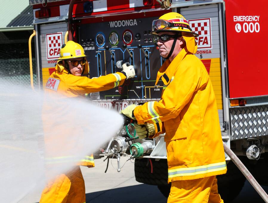 READY FOR ACTION: Firefighter Nathan Bell and leading firefighter Ross Iudica have been training with the Wodonga Fire Brigade ready for structure or bushfires this season. Pictures: JAMES WILTSHIRE