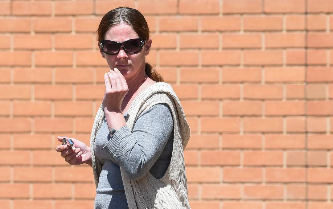 ACCUSED: Lisa Hay lights up a cigarette outside Wodonga Court yesterday, where she will face trial over the next week for alleged arson.
