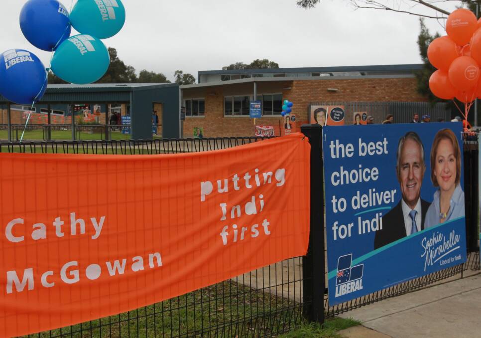 DUELING COLOURS: The homemade banners of Cathy McGowan contrasted Sophie Mirabella's Liberal signage featuring Prime Minister Malcolm Turnbull.