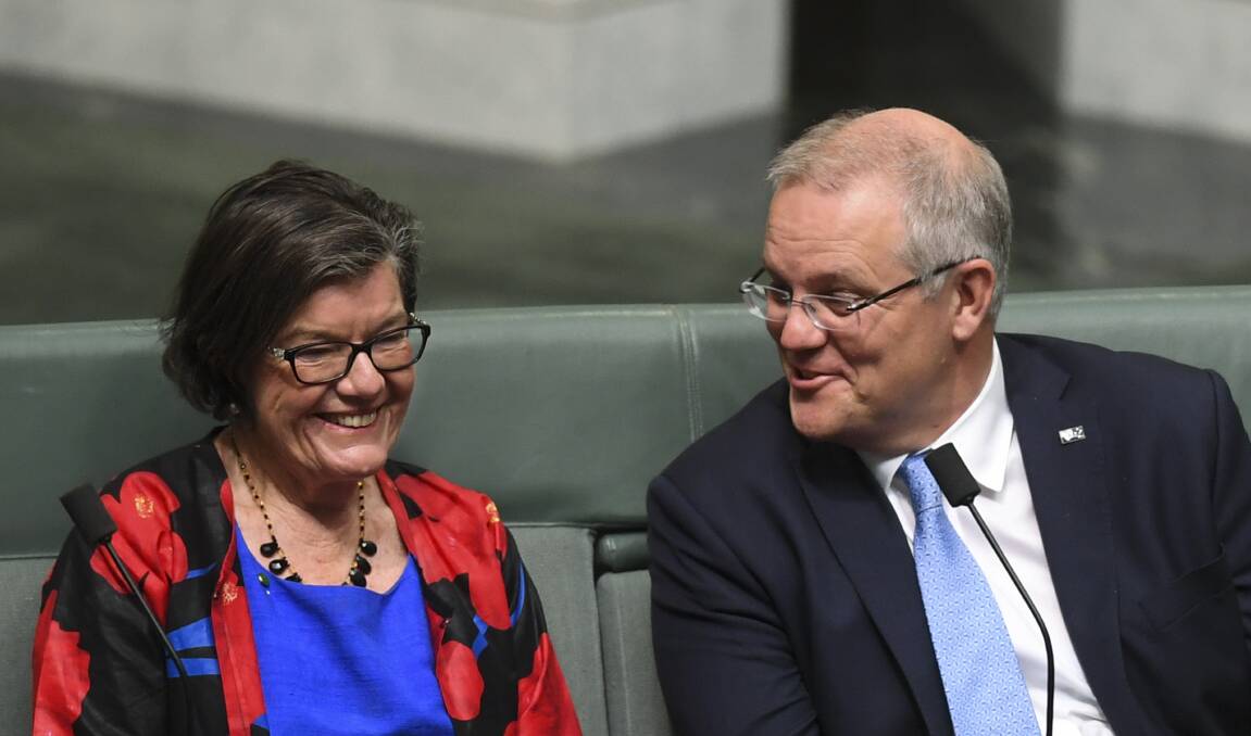 SMILES, BUT DISAGREEMENT: Indi MP Cathy McGowan and Prime Minister Scott Morrison during a division in the House of Representatives. Picture: AAP