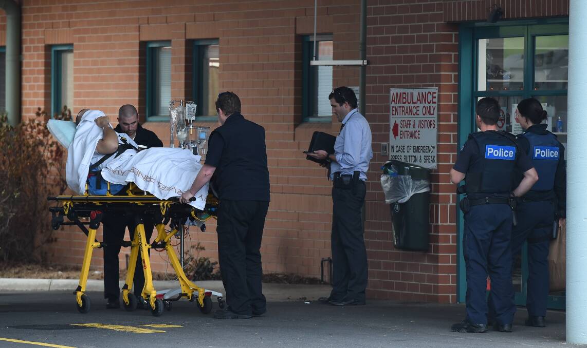 UNDER ARREST: Joshua Clavell leaving hospital in Albury before he was extradited back to Victoria.