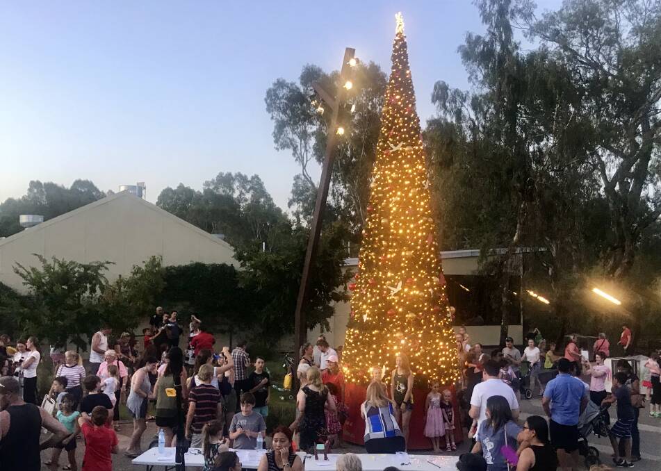 BRIGHT LIGHTS OF CHRISTMAS: The crowd gathered around the tree at the Ovens Riverside Square on Thursday night as the lights were turned on for the first time.