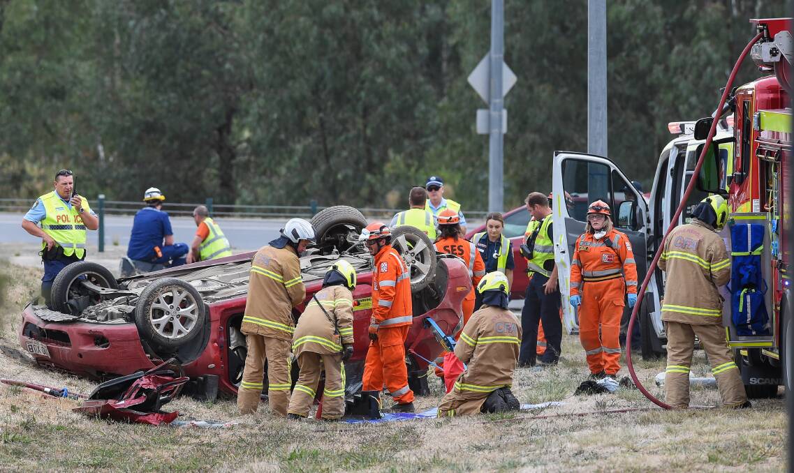 CRASH SCENE: Emergency services including both NSW and Victoria police attended the Wodonga crash after a red sedan hit another car and flipped onto its roof. Picture: MARK JESSER