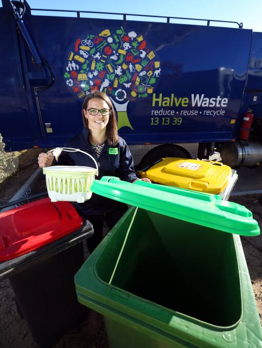 BE GREEN: Cleanaway project education and communication manager Nina McHardy with the set of waste, organic and recycling bins introduced this year.