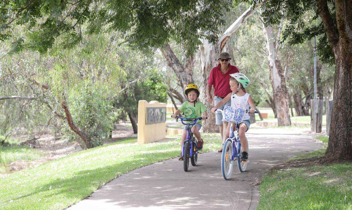 POPULAR SPOT: Dan O'Connell with his grandchildren, Michael, 4, and Elizabeth O'Connell, 7, from Albury, at Gateway Island yesterday. Picture: JAMES WILTSHIRE