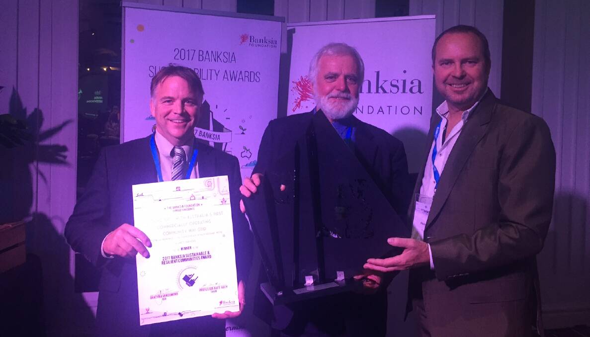 WINNERS: Totally Renewable Yackandandah's Matthew Charles-Jones and Denis Ginnivan presented with their sustainable and resilient communities award by Ross Wyatt from the Banksia Foundation on Wednesday.