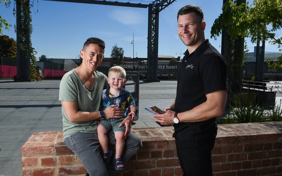 CONSULTATION: Marco Dodds and son MJ Dodds, 1, with ARTC corporate affairs general manager Bas Bolyn at Junction Square. Picture: MARK JESSER
