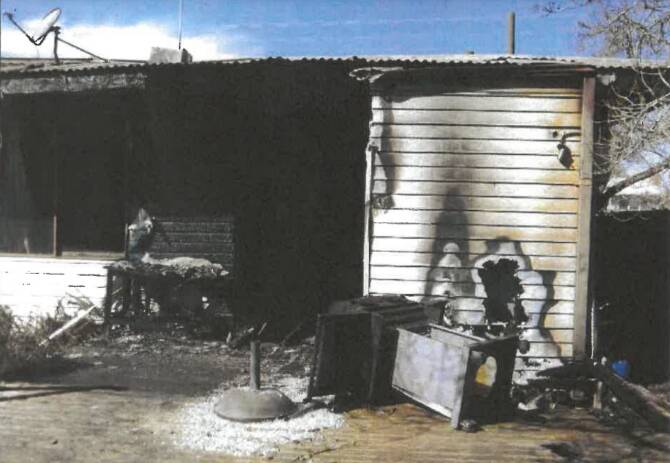 DESTROYED: Police photographs showed the fire started at the back door.