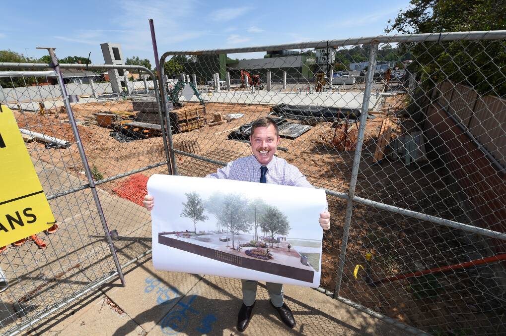 CONSTRUCTION: Cr Dave Fuller with plans for rail precinct upgrades, in front of construction of Quest apartments and the new Dan Murphy's store. Picture: MARK JESSER