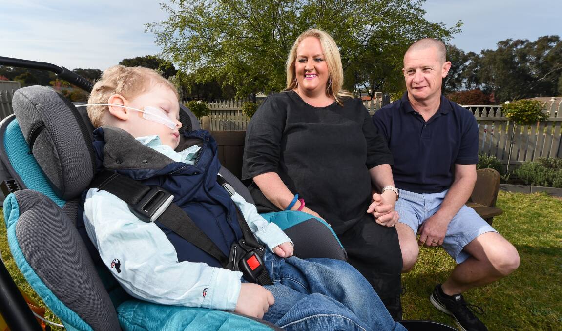 CROSS-BORDER PAIN: Charlie, 4 with parents Kate and Brad Smith. Picture: MARK JESSER