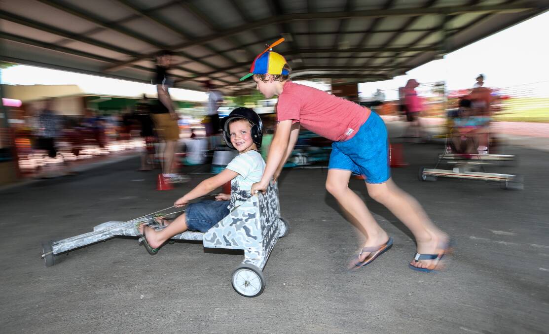 FAST WORK: Saxon, 8, and Connor Ashlin, 9, enjoyed making their own go kart at the children's fair, then testing it out with a ride around the track.