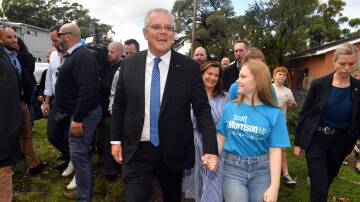 Prime Minister Scott Morrison with wife Jenny, and daughters Lily and Abbey arrive to vote at the Lilli Pilli Public School on election day. Picture: AAP