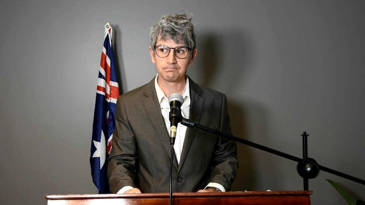 ADDRESS: Faux chief health advisor Greg Tristan addresses the media about the government's failed attempt to vaccinate against the Christmas spirit. 