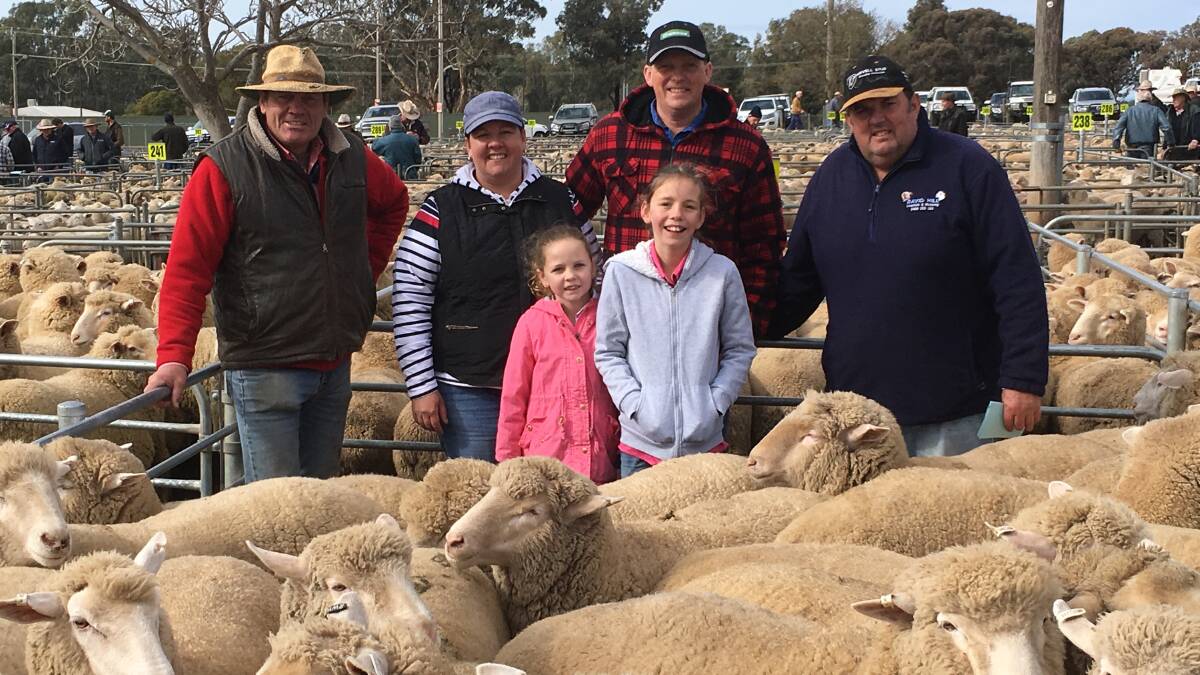 WELL STOCKED: Elders auctioneer Stephen Grantham with vendors Nicole, Lily, Natasha and Peter Beckett and David Hill, Elders livestock, with the pen of 70 lambs sold for a Corowa sale yard record of $281.60 on Monday, July 23.