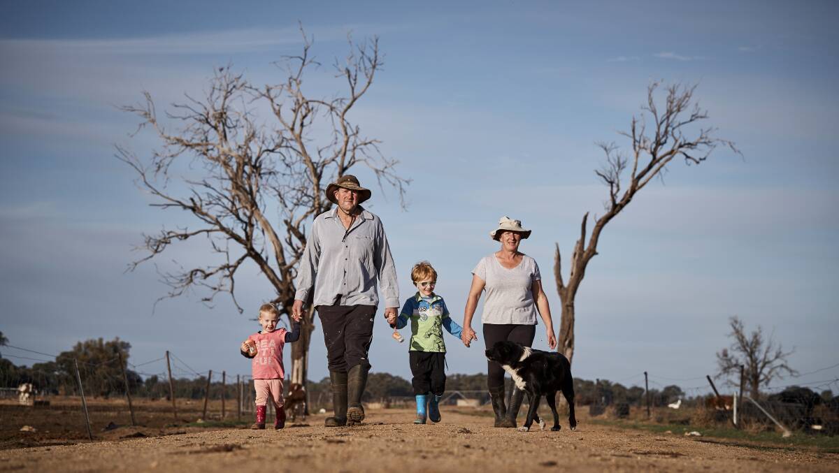 Dairy farmers Barry and Rosey Warburton with their two children.