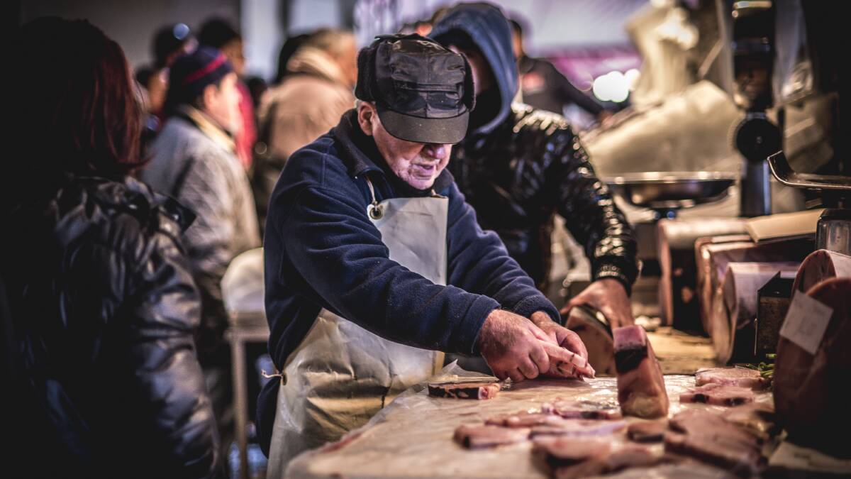 A vendor cuts fish at the traditional fish market in Catania. Picture: Shutterstock
