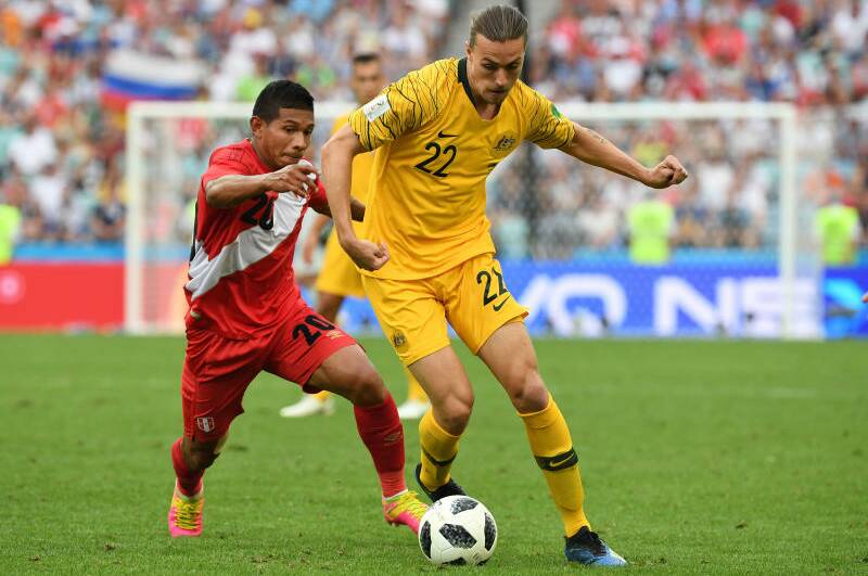 Australia's Jackson Irvine comes under pressure from Edison Flores of Peru. Photo: AAP