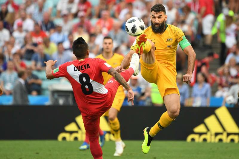 Australia's Mile Jedinak and Christian Cueva of Peru in a contest for the ball during their final FIFA World Cup group match. Photo: AAP
