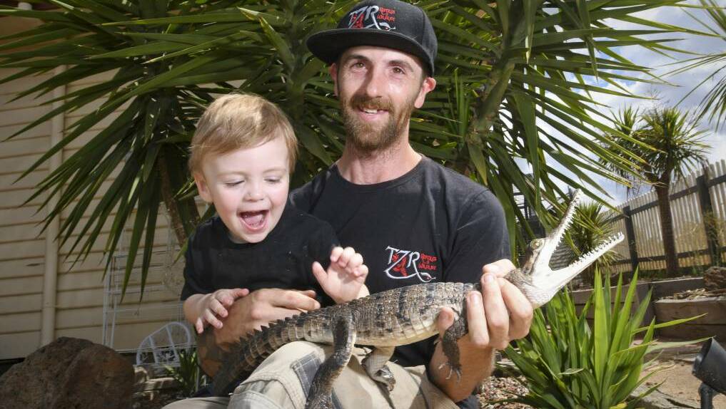 Bendigo snake catcher Chris Page is already teaching his two-year-old son Ethan about protecting and respecting wildlife. Picture: NONI HYETT