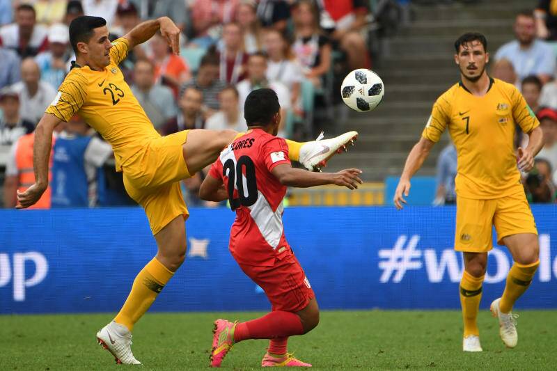 Australia's Tom Rogic comes under pressure from Edison Floresy of Peru. Photo: AAP