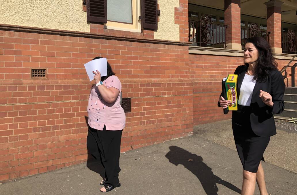 GUILTY: Tracy Lee Dowling, 41, hides her face as she leaves Wagga District Court with her solicitor moments after being convicted of the manslaughter of 20-year-old Cootamundra man Luke Doyle. 