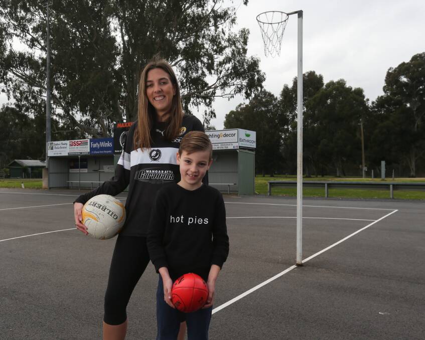 PIES: Wangaratta netballer Rachelle Petts and her oldest son, Carter, 6, at the home of the Magpies at Norm Minns Oval. Petts is in the midst of her first season of A-grade netball with the reigning premiers. Picture: TARA TREWHELLA
