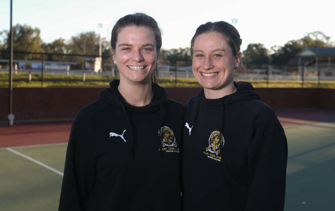 TIGERS: Karina Cameron (right) pictured alongside teammate Emily Rodd. Cameron took out Albury's A-grade best and fairest award this season.