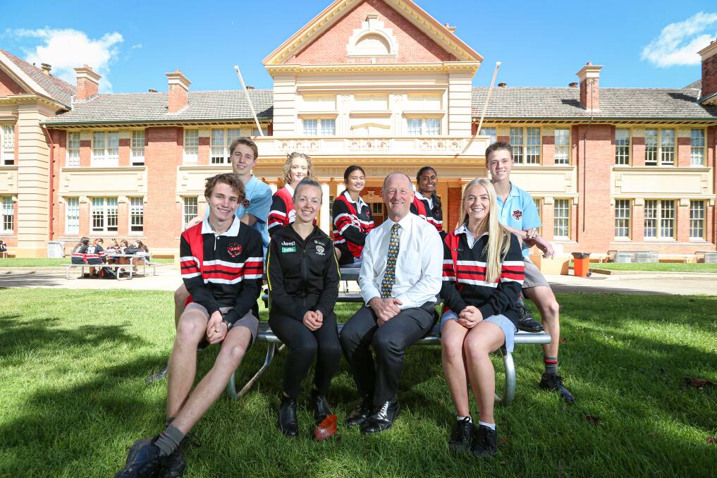 EXCITED: RISL's Jess Harris with Albury High School principal Darryl Ward and students after announcing the partnership. Picture: JAMES WILTSHIRE.