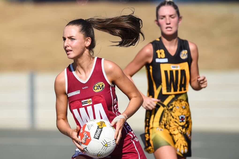 SWELTERING: Wodonga Bulldogs Kellie McDonald braves the heat in the midcourt during Saturday's game at Martin Park.
