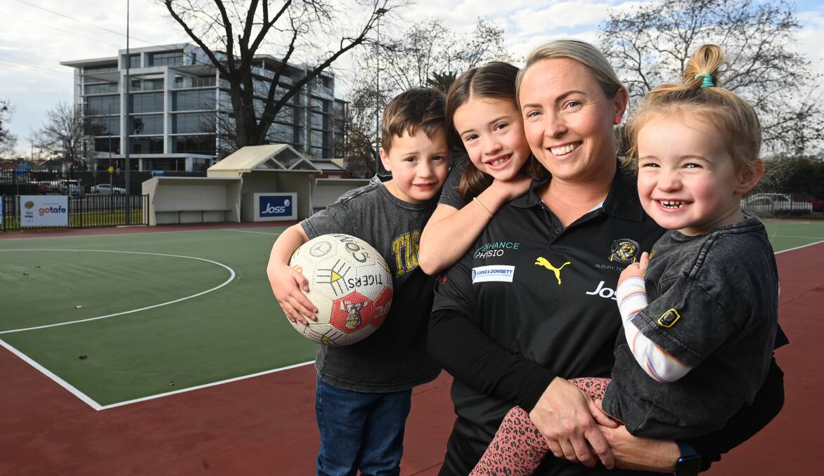 MUM'S THE WORD: Tiger Karlee Nolan with her kids Harry, 4, Pippa, 7 and Annie, 2 ahead of her 300th netball game for Albury. Picture: MARK JESSER