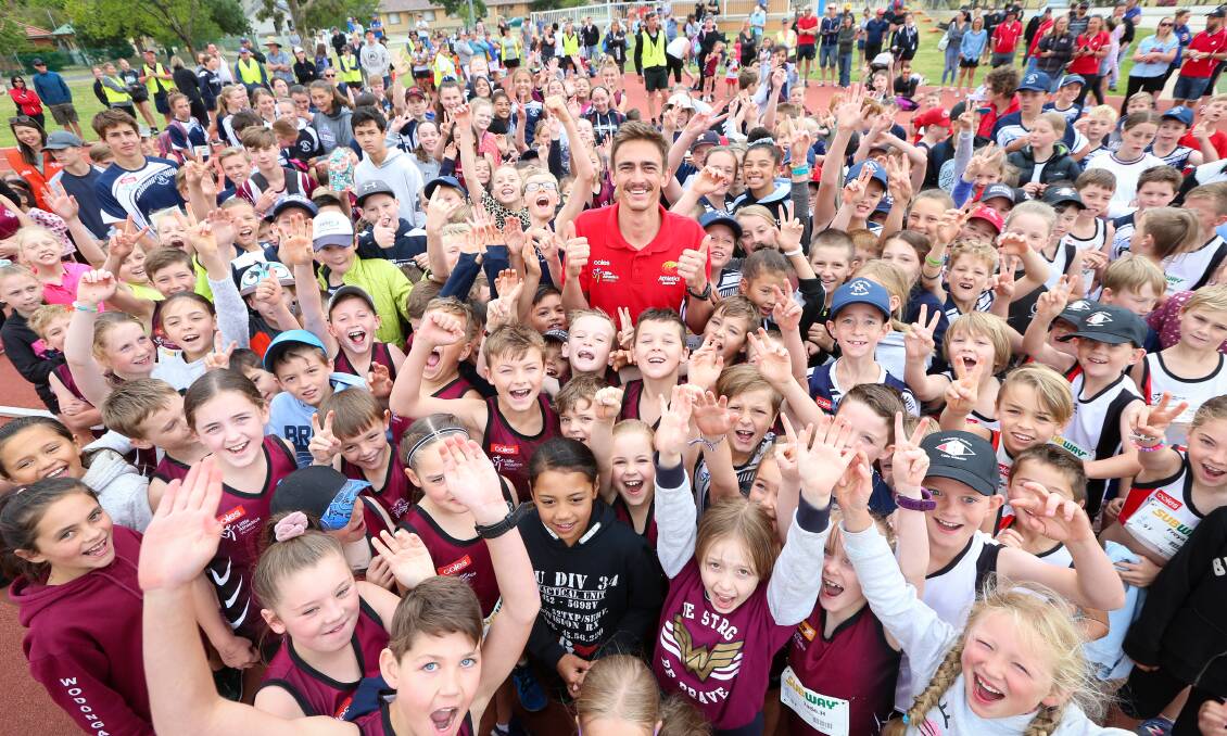 ALL SMILES: Australian high jumper Brandon Starc surrounded by the Border's young athletes in Albury on Saturday. Picture: JAMES WILTSHIRE