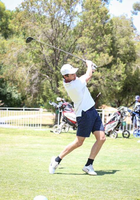 BIG SWING: Ben Hollands tees off during the Upper Murray Fire Charity Golf Day held in Wodonga on Friday. Pictures: JAMES WILTSHIRE.