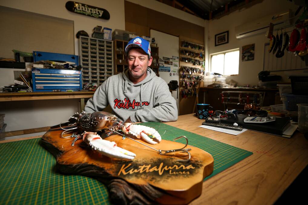 HOOK: Bundalong's Aaron Young admires his own handcrafted crayfish lure. Pictures: JAMES WILTSHIRE