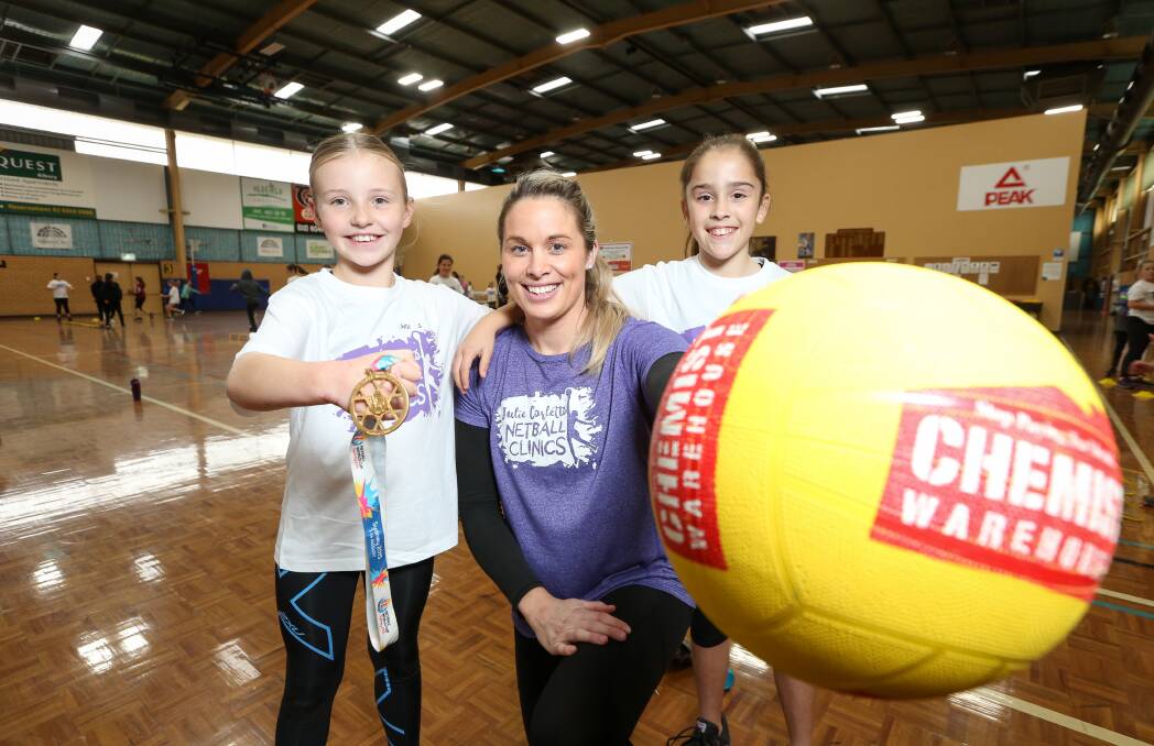 GOLDEN GIRL: Retired Australian Diamond's player Julie Corletto with Border youngsters Indi Sibraa and Emilie Yensch on Friday. Picture: JAMES WILTSHIRE.