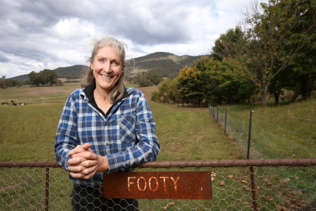 HOME SWEET HOME: Dederang's Sharon McEvoy at her family's farm, in front of the paddock that was once used by her kids as a home football field. Picture: JAMES WILTSHIRE