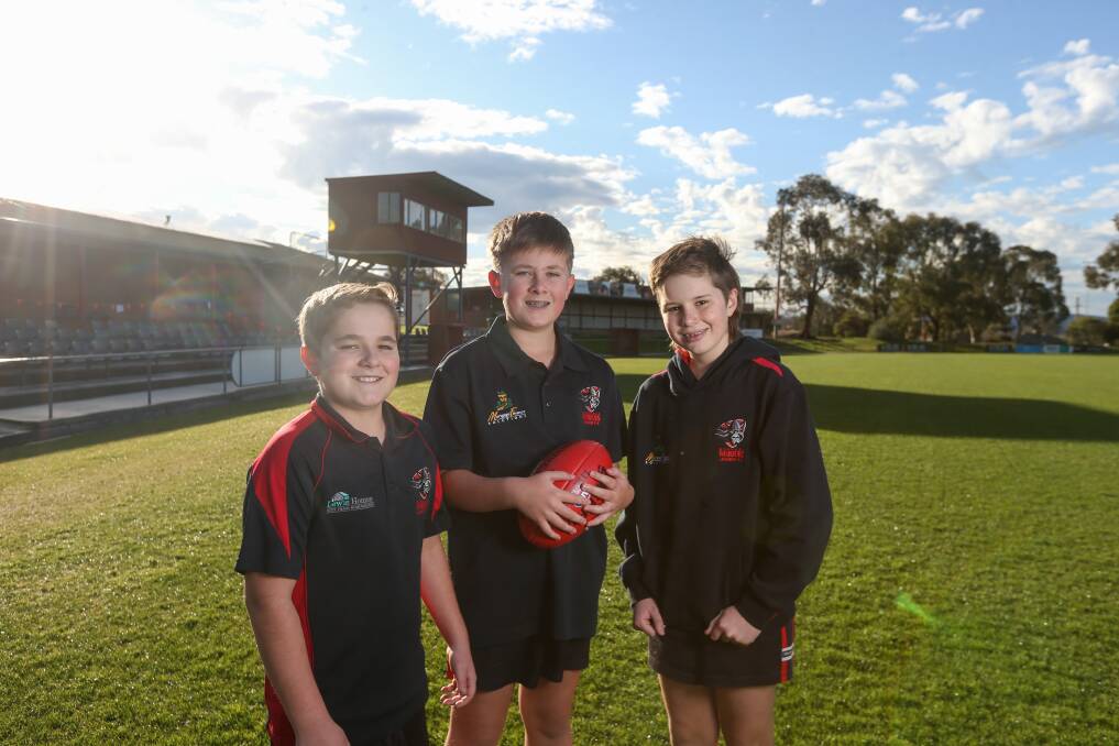 ALL SMILES: Wodonga Raiders junior players Ashton Everett, Flynn Stewart and Zac Deegan will get a chance to play this season with the league announcing a competition start date. Picture: TARA TREWHELLA