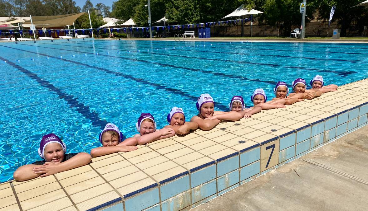 POOL TIME: Youngsters are back in the water for FlippaBall wearing purple caps in memory of late O and M water polo member Marg Moran. Picture: NATALIE BEDDOES