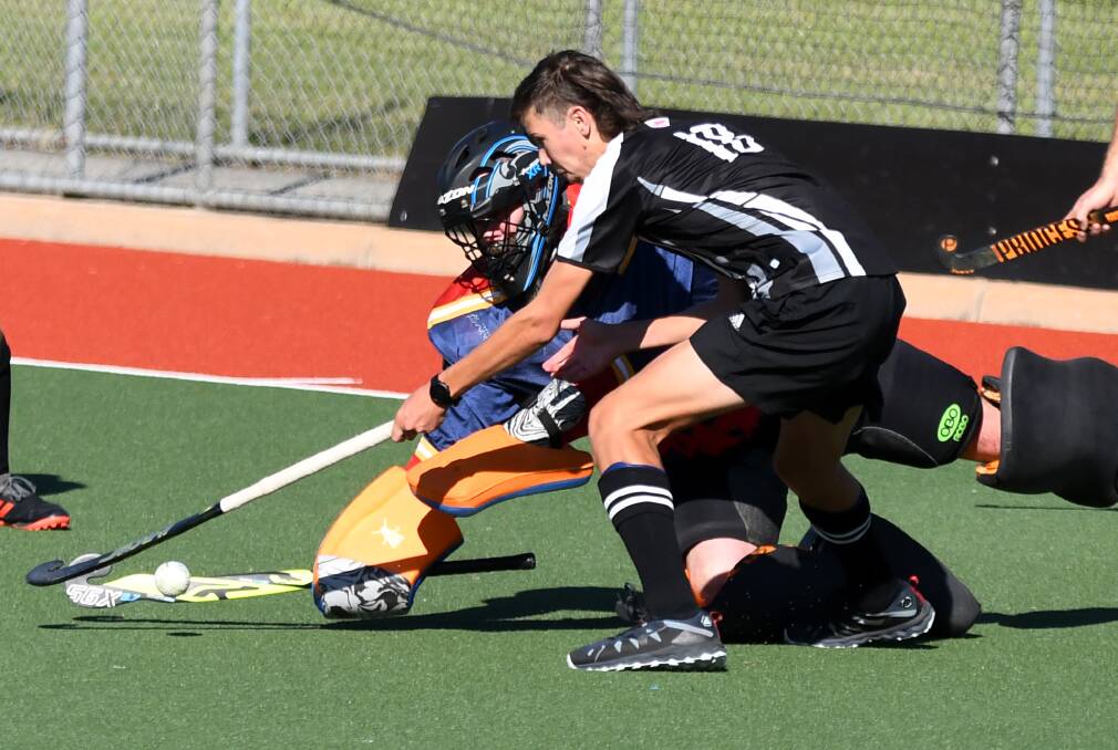 IN THE ZONE: Hamish Morrison of Magpies attempts to get around goal keeper Andy Paterson of Falcons during the sides' clash on the weekend. Picture: supplied