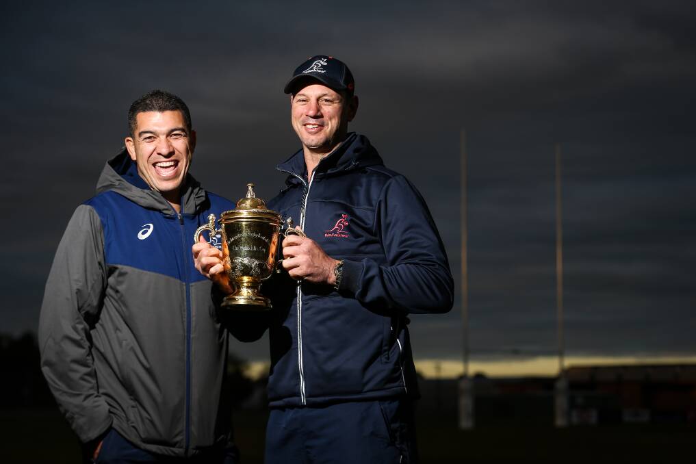 CUP FEVER: Classic Wallabies Mark Gerrard and Matt Cockbain with the Rugby World Cup trophy at Albury's Murrayfield on Tuesday. Picture: JAMES WILTSHIRE