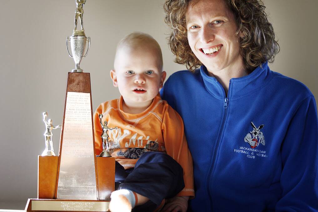 FROM THE ARCHIVES: Rebecca Stamp and her son Will after claiming her first Tallangatta and District League A-grade netball best and fairest award back in 2006.