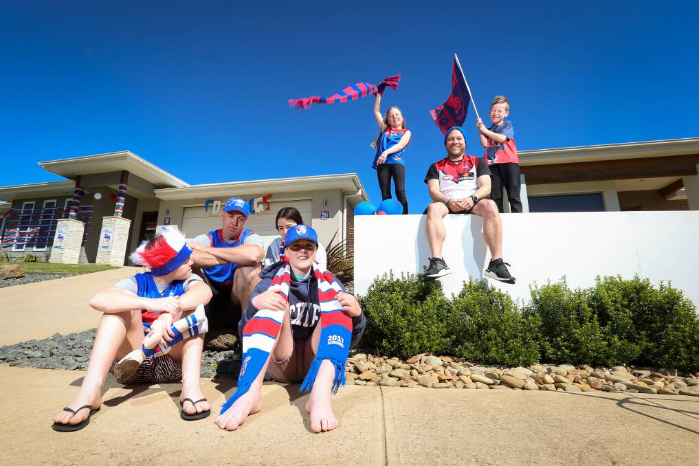 DIVIDED: Steve Bradshaw with kids Jett, 10 Bodhi, 13 and Bella, 15 with neighbours the Harris' Mark, Jorja, 9 and Will, 6 following the AFL Grand Final. Picture: JAMES WILTSHIRE